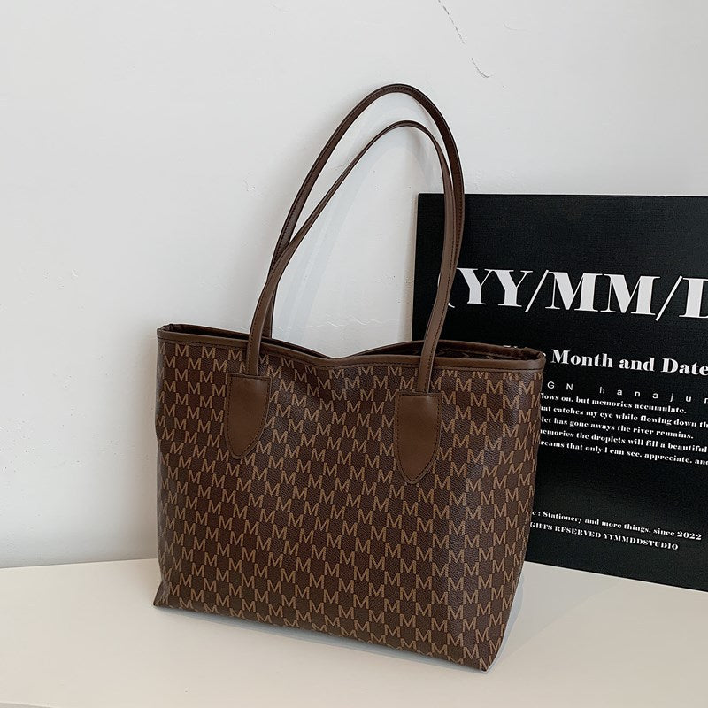 Ladies tote bag made of high-quality, durable material with elegant monogram