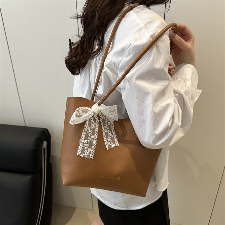 Women’s tote bag made of high-quality synthetic leather with playful bow detail