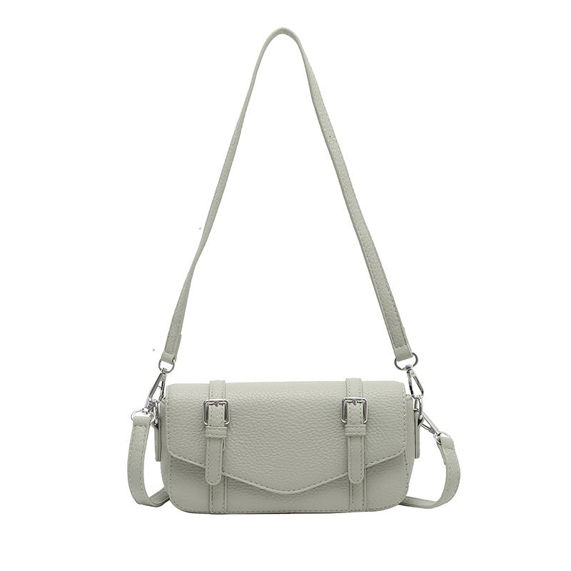 Women's elegant shoulder bag made of textured synthetic leather with adjustable shoulder strap