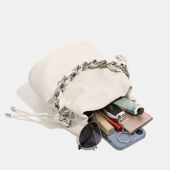 Women's mini backpack bag with elegant chain handle and fine texture