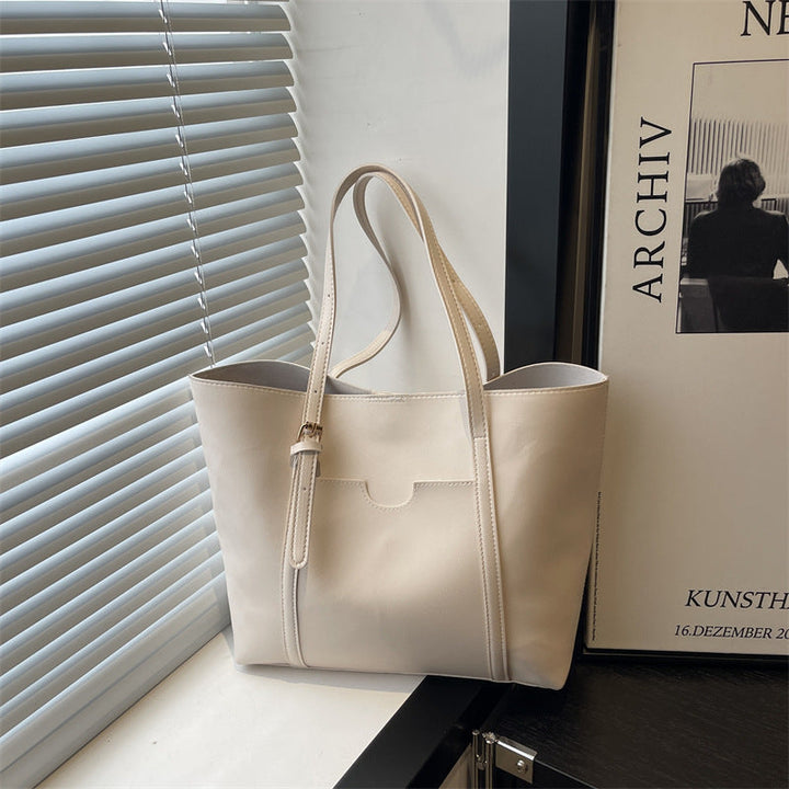 Women's tote bag made of structured synthetic leather with stylish detail