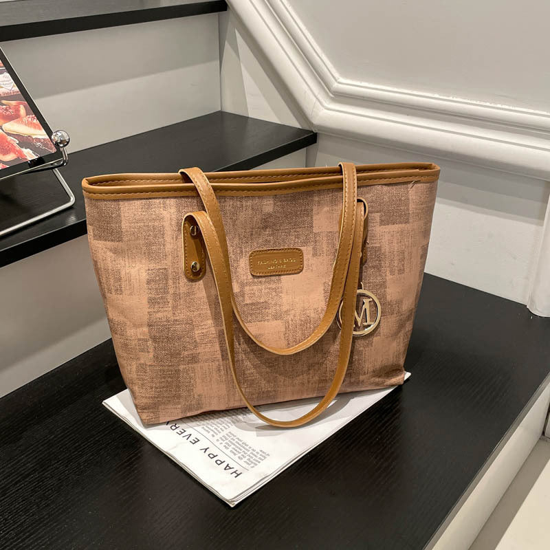 Women's stylish tote bag with textured design and elegant details
