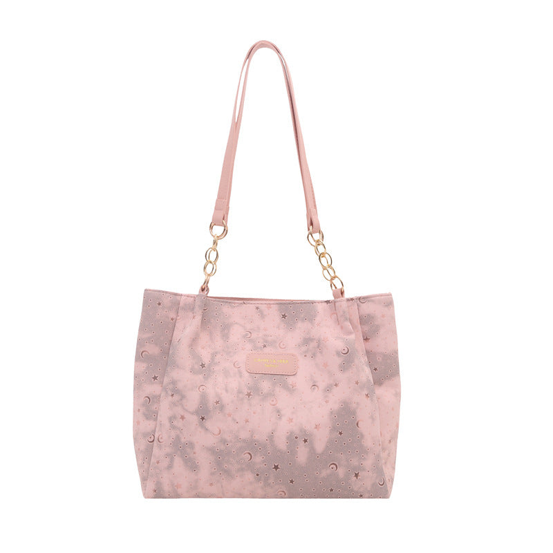 Women’s stylish tote bag with playful pendant