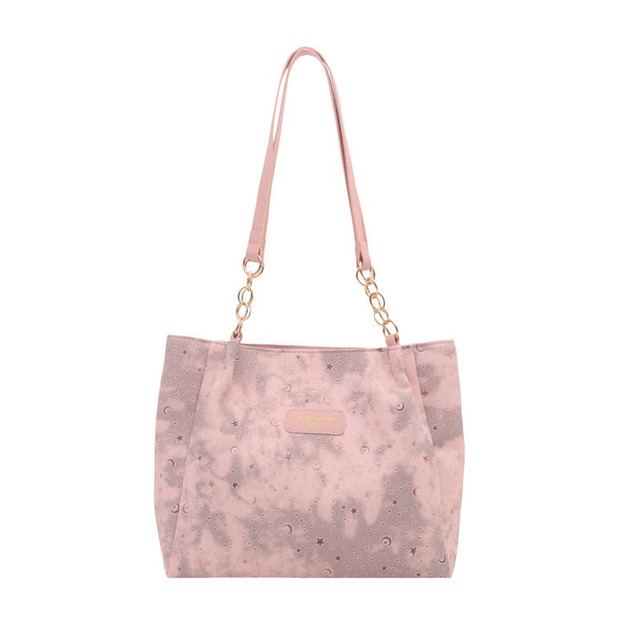 Women’s stylish tote bag with playful pendant