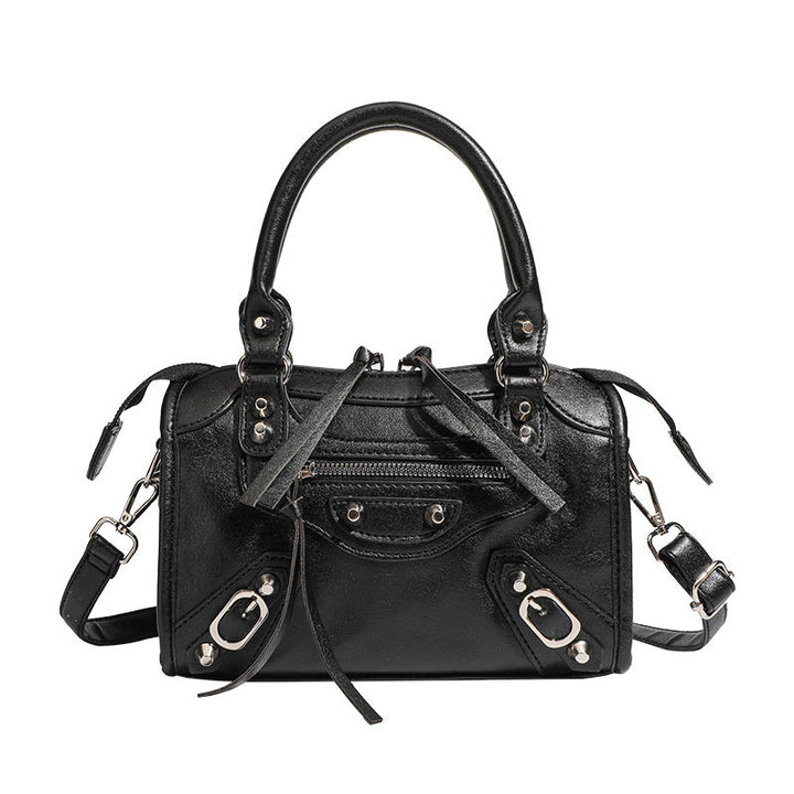 Women's mini handbag with decorative metal accents and removable shoulder strap