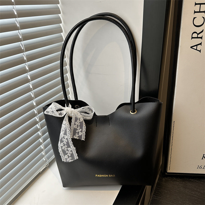 Women’s tote bag made of high-quality synthetic leather with playful bow detail