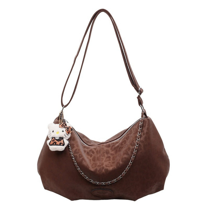 Ladies elegant hobo bag made of structured synthetic leather with detachable tag