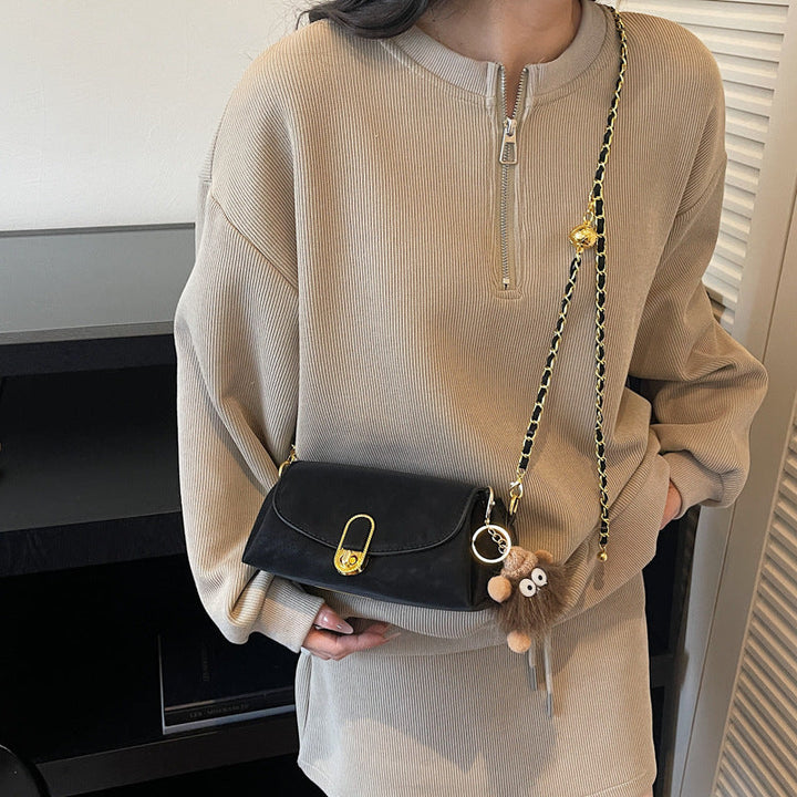 Women's shoulder bag with decorative pendant and luxurious chain strap