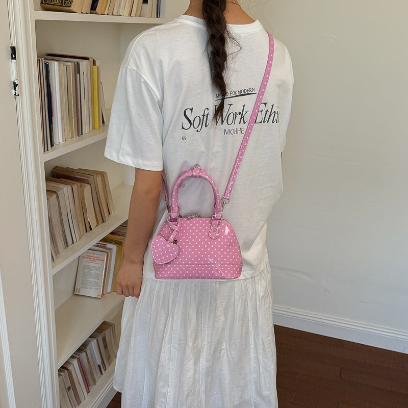 Women’s mini handbag with playful polka dot pattern and detachable shoulder strap