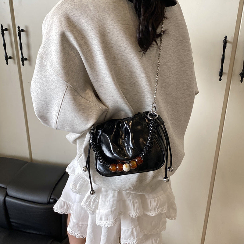 Ladies mini shoulder bag with decorative chain strap and trendy charm