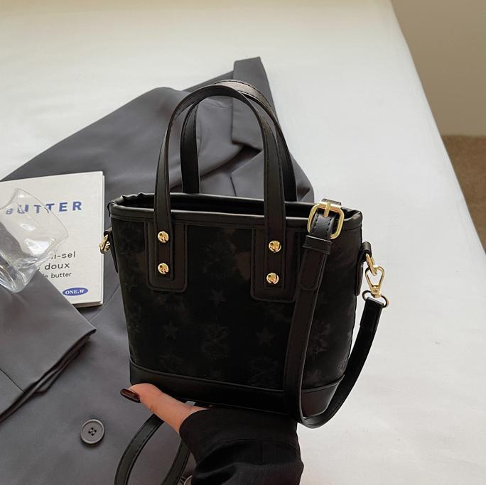Ladies mini bag in playful design with decorative charm