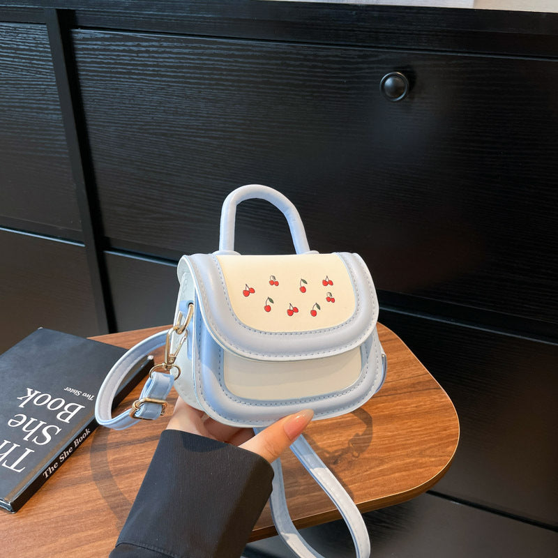 Women's mini handbag with cheerful cherry design and charming pendants