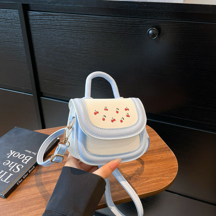 Women's mini handbag with cheerful cherry design and charming pendants