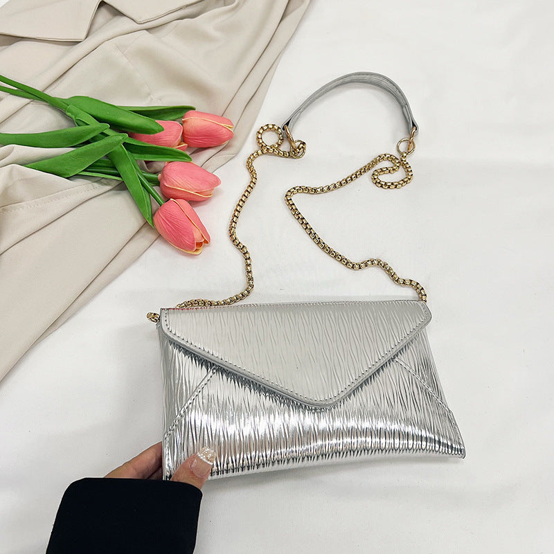 Women's elegant clutch with shiny upper material