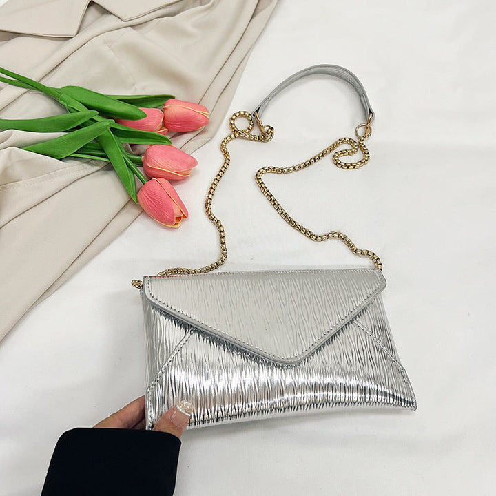 Women's elegant clutch with shiny upper material