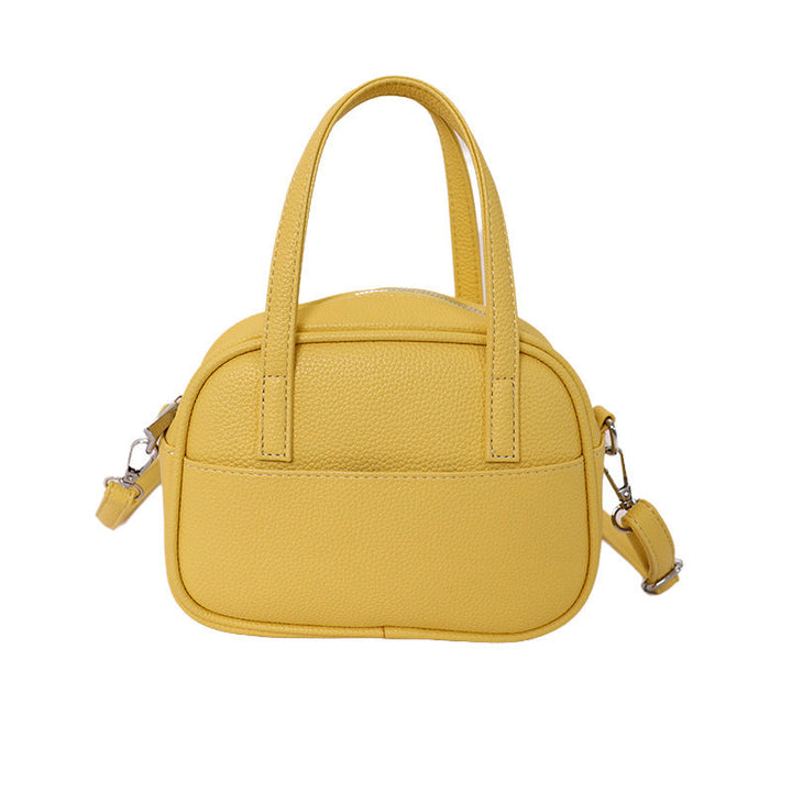 Women's mini handbag with playful animal charm