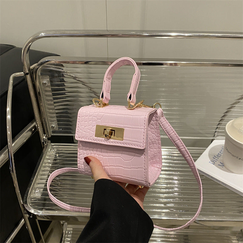 Ladies mini bag with elegant crocodile look and golden accents