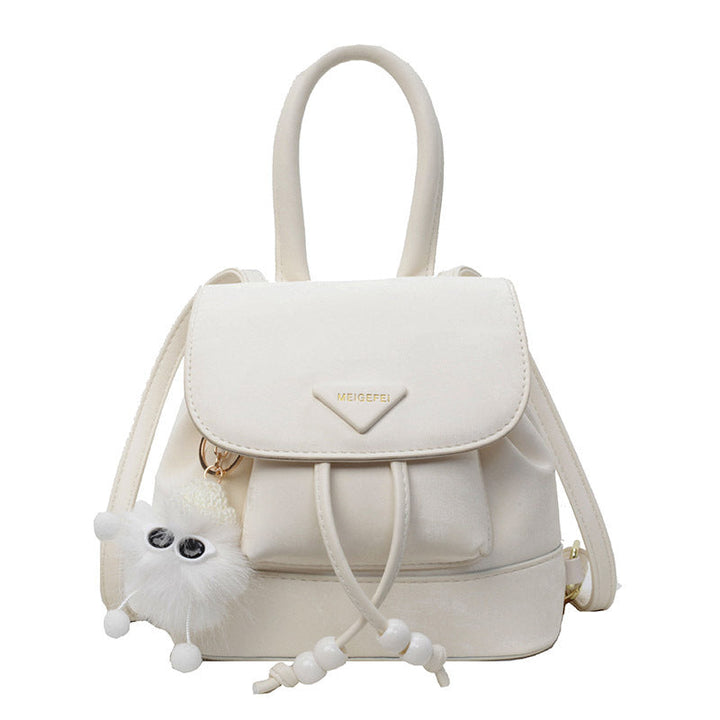 Women's mini backpack with playful design and plush pendant