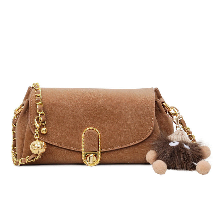Women's shoulder bag with decorative pendant and luxurious chain strap