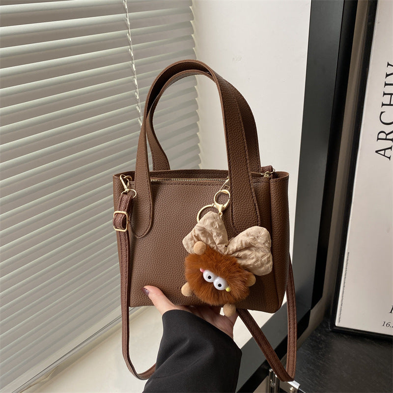 Women’s mini bag with playful animal pendant