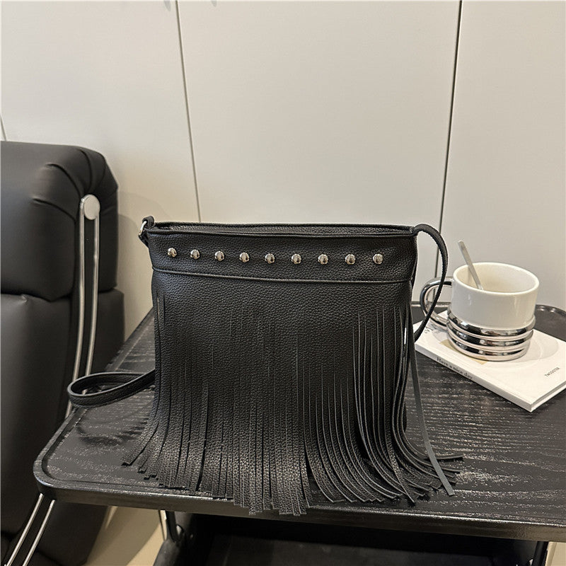 Ladies shoulder bag with fringes and studs