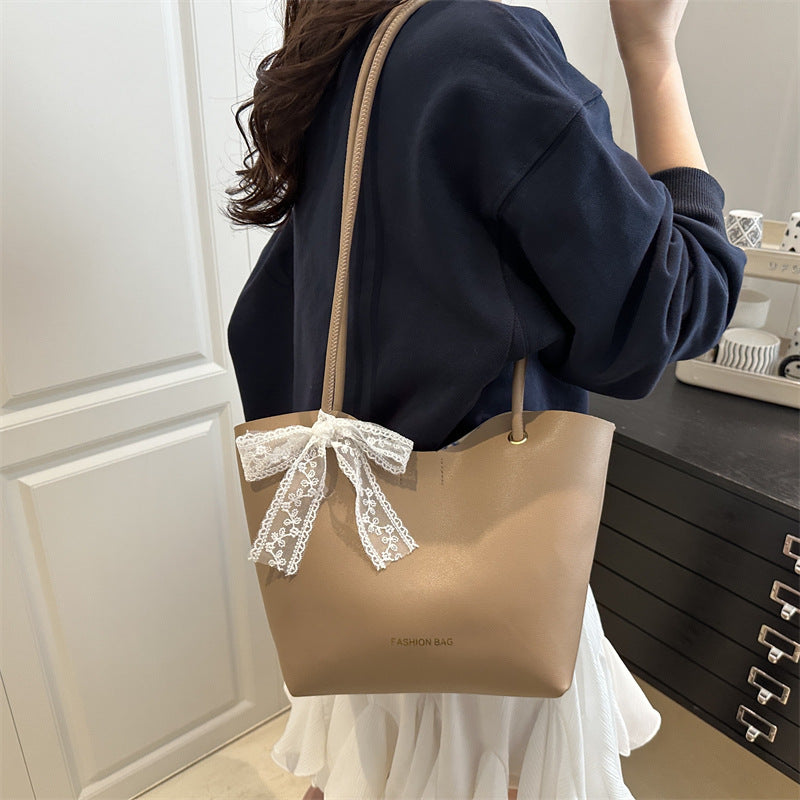 Women’s tote bag made of high-quality synthetic leather with playful bow detail