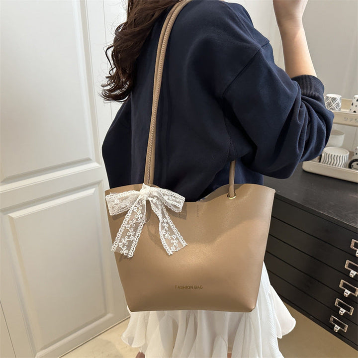 Women’s tote bag made of high-quality synthetic leather with playful bow detail