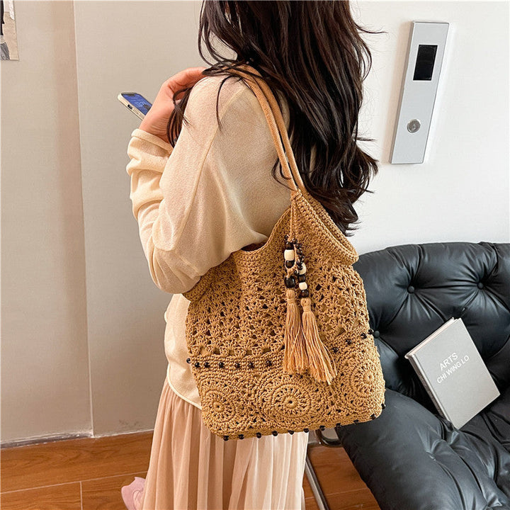 Ladies crocheted shoulder bag with decorative fringes and unique accents