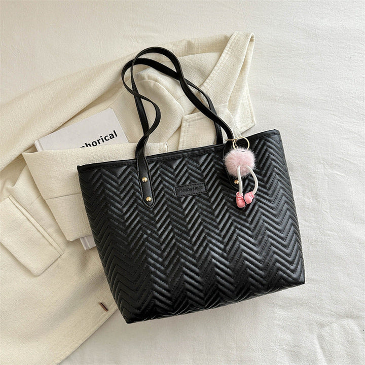 Women's leisure tote bag with textured wave pattern and charming pendant
