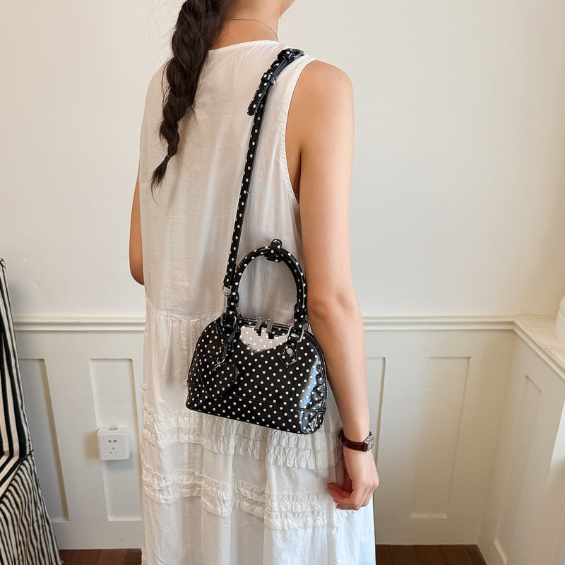Women’s mini handbag with playful polka dot pattern and detachable shoulder strap