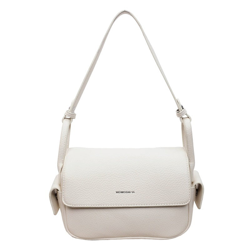 Women’s shoulder bag made of soft, textured leather with adjustable shoulder strap