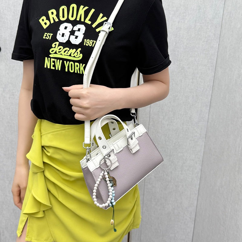 Women's mini handbag with playful pendant and elegant design