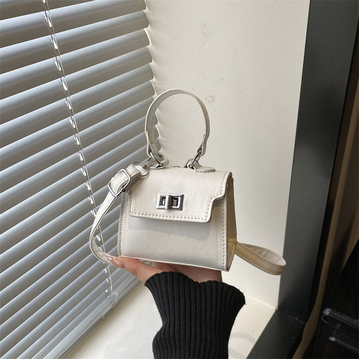 Ladies mini handbag with luxurious leather look and practical carrying handles