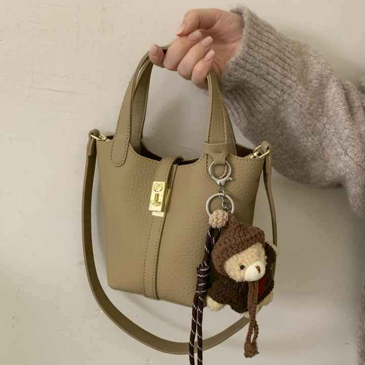 Women's mini handbag with playful animal charm