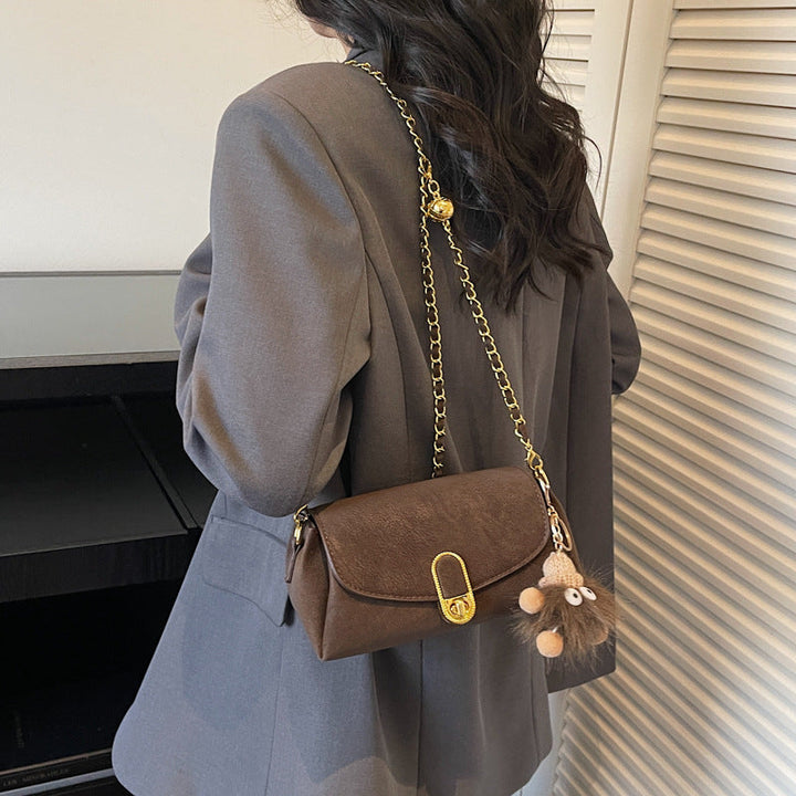 Women's shoulder bag with decorative pendant and luxurious chain strap