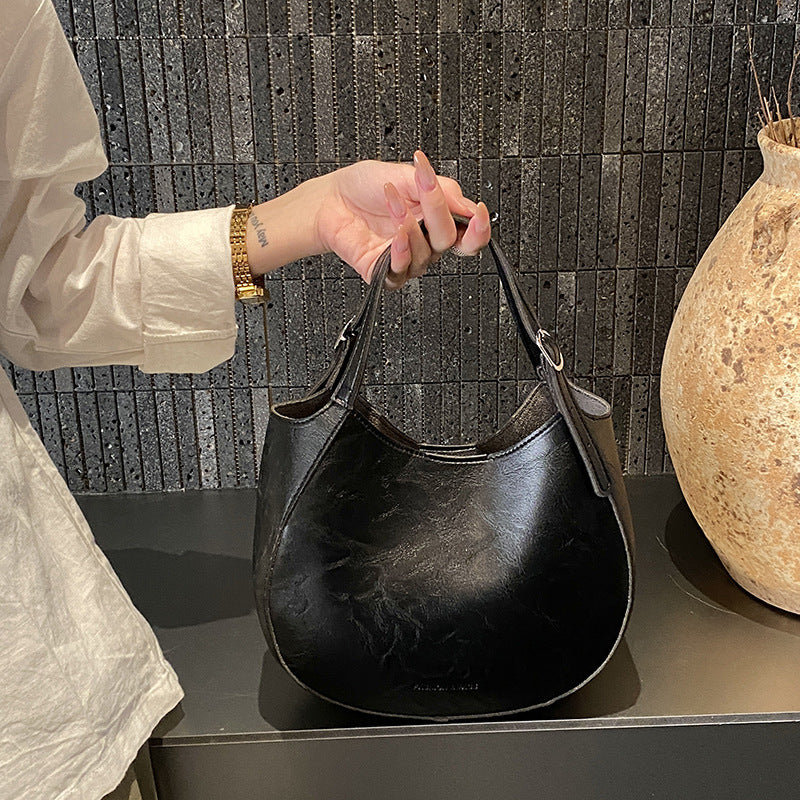 Women's shoulder bag made of high-quality artificial leather with fashionable trim