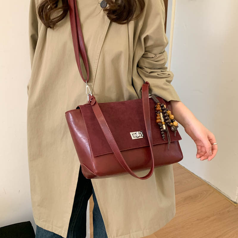 Women's elegant shoulder bag made of high-quality faux leather with playful charm