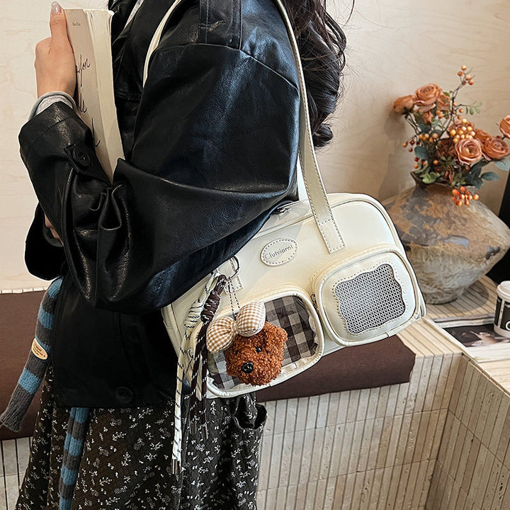 Women's shoulder bag with unique drawstring and charming pendant