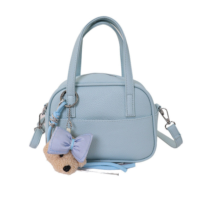 Women's mini handbag with playful animal charm