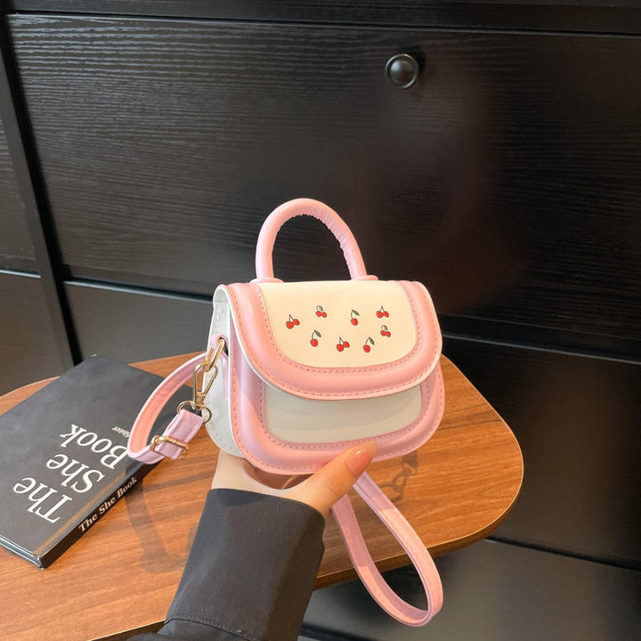 Women's mini handbag with cheerful cherry design and charming pendants