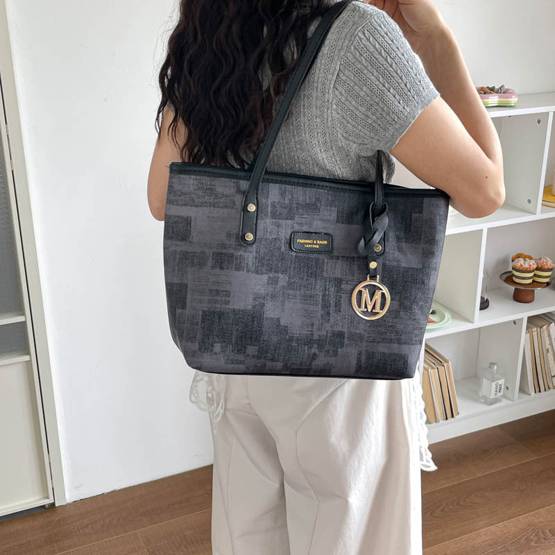 Women's stylish tote bag with textured design and elegant details