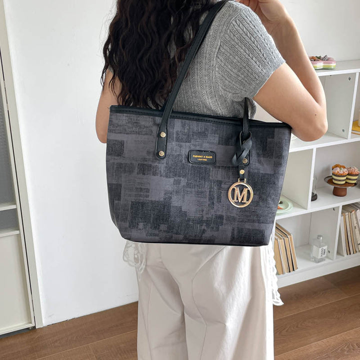 Women's stylish tote bag with textured design and elegant details