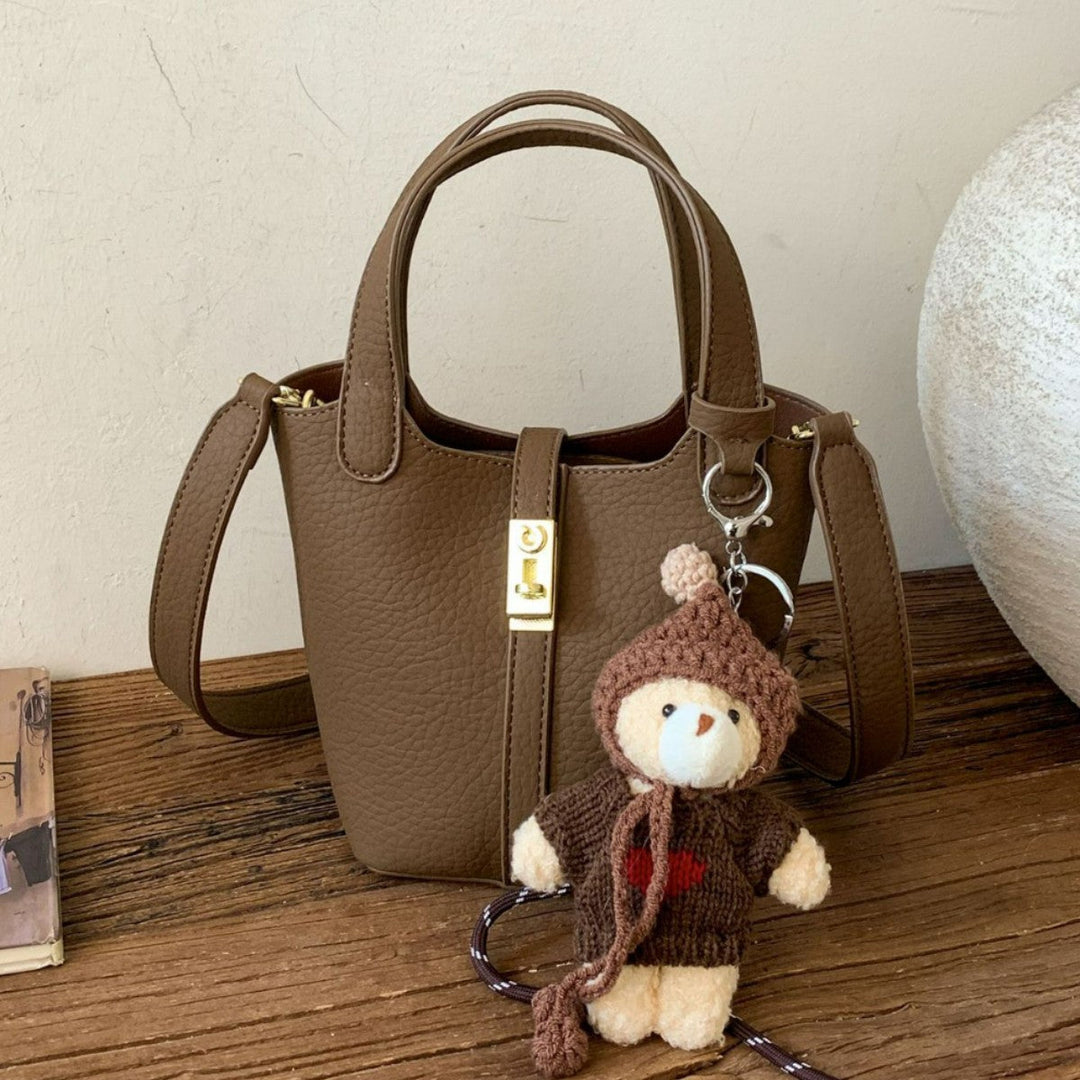 Women's mini handbag with playful animal charm