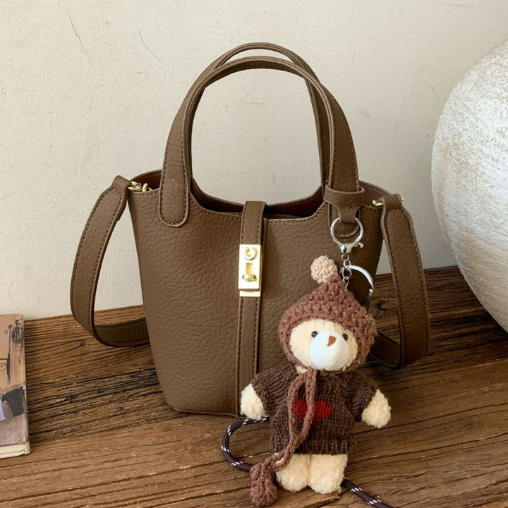 Women's mini handbag with playful animal charm