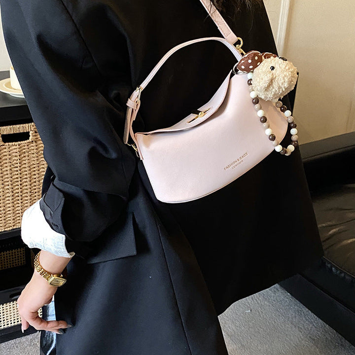 Women's shoulder bag with decorative pendant