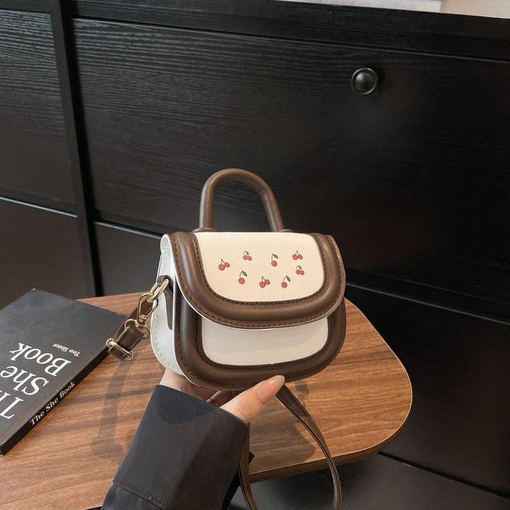 Women's mini handbag with cheerful cherry design and charming pendants