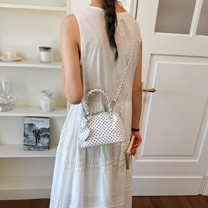 Women’s mini handbag with playful polka dot pattern and detachable shoulder strap