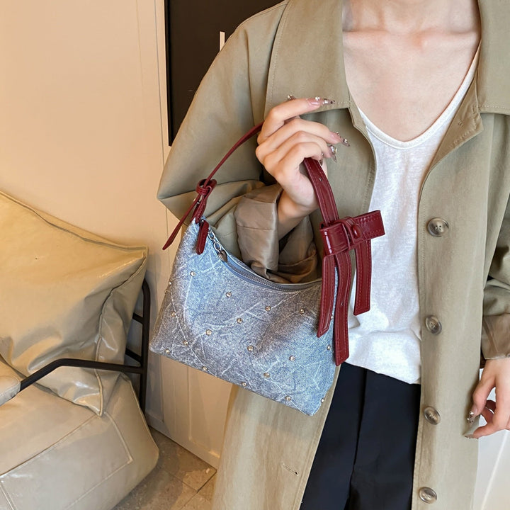 Ladies fashionable shoulder bag with sparkling appliqués