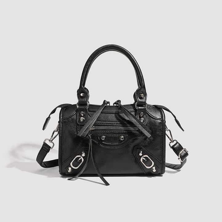 Women's mini handbag with decorative metal accents and removable shoulder strap