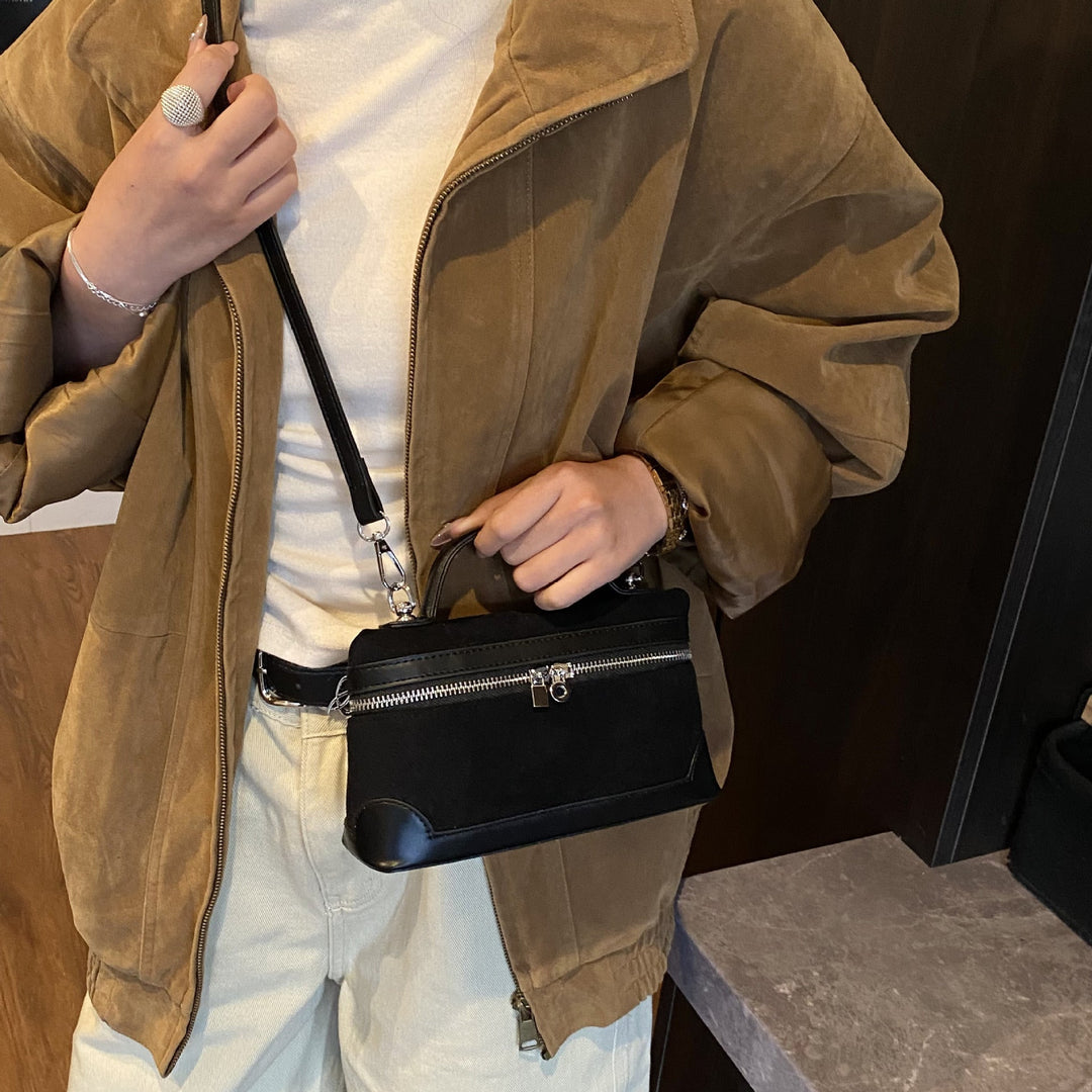 Women's shoulder bag made of soft suede leather with practical compartments